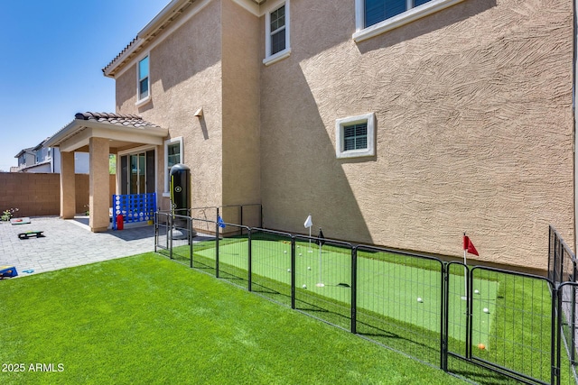 exterior space featuring a fenced backyard, a patio area, and a gate