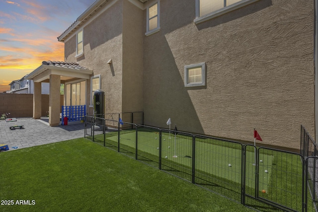exterior space featuring a patio area, a fenced backyard, and a gate