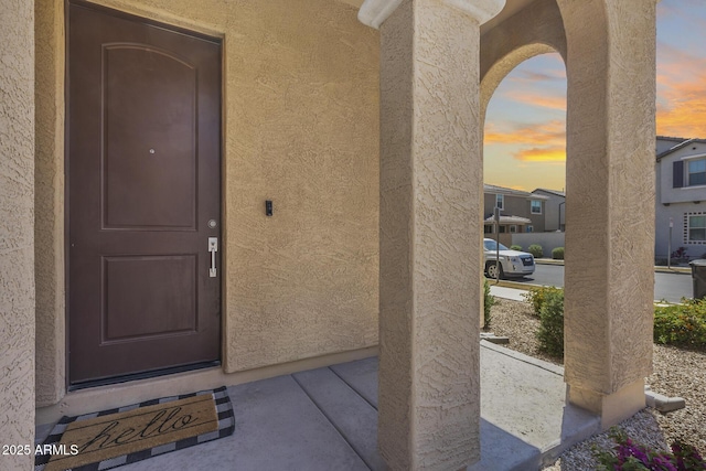 property entrance featuring stucco siding