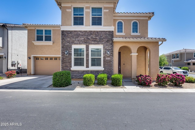 mediterranean / spanish home featuring driveway, stucco siding, and a garage