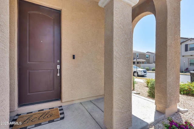 doorway to property with stucco siding