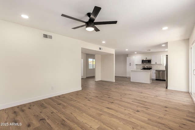 1521 W Jacinto Ave, Mesa, AZ 85202 - unfurnished living room with recessed lighting, ceiling fan, and light wood-style floors