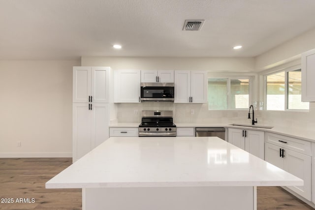 1521 W Jacinto Ave, Mesa, AZ 85202 - kitchen with appliances with stainless steel finishes, decorative backsplash, wood finished floors, light countertops, and recessed lighting