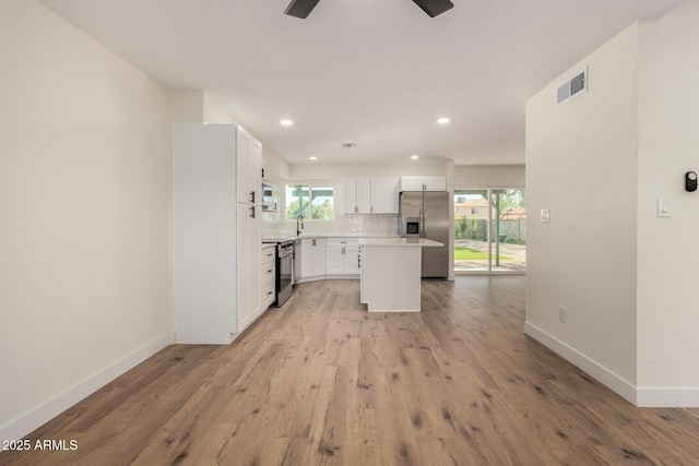 1521 W Jacinto Ave, Mesa, AZ 85202 - kitchen with stainless steel fridge with ice dispenser, a ceiling fan, decorative backsplash, a center island, and light wood finished floors