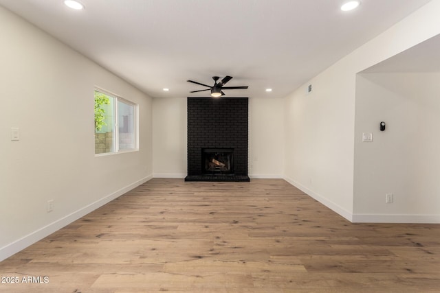 1521 W Jacinto Ave, Mesa, AZ 85202 - unfurnished living room with ceiling fan, recessed lighting, light wood-style flooring, and a brick fireplace