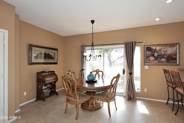 dining area with baseboards, an inviting chandelier, and light tile patterned floors