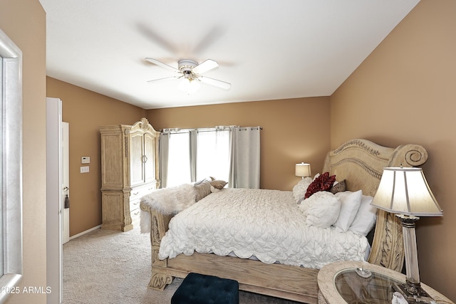 carpeted bedroom featuring ceiling fan and baseboards