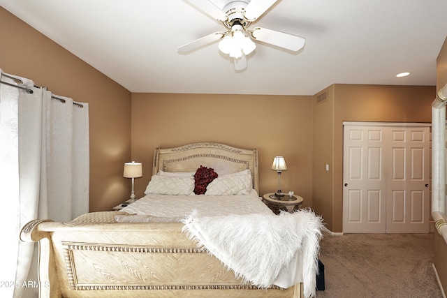 carpeted bedroom featuring ceiling fan and visible vents