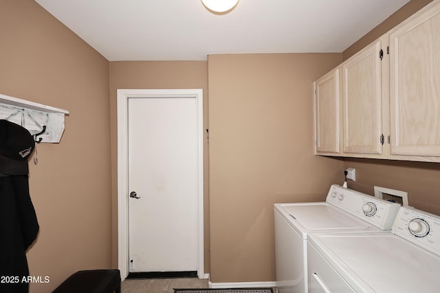 clothes washing area with washer and dryer and cabinet space