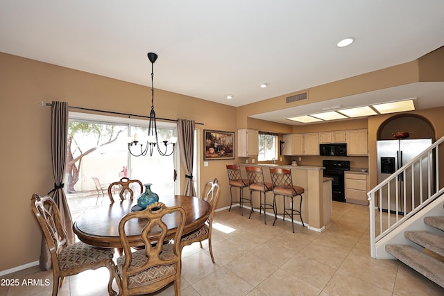 dining space with stairs, a wealth of natural light, a chandelier, and visible vents