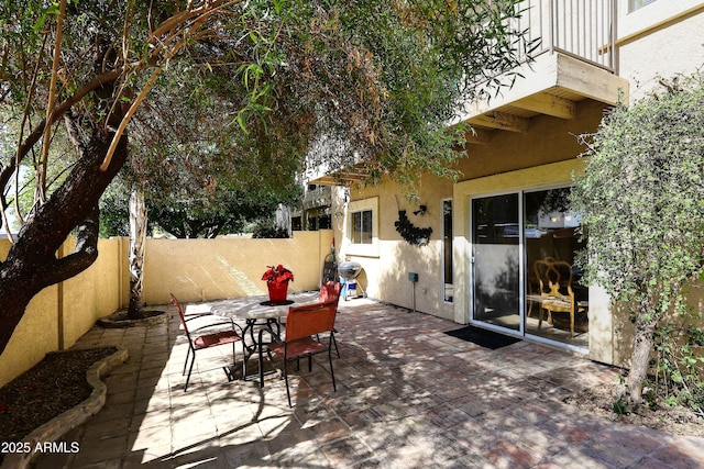 view of patio with fence and outdoor dining area