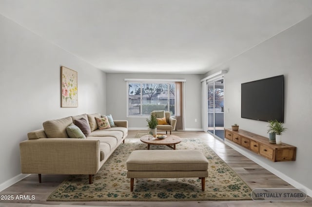 living room with wood finished floors and baseboards