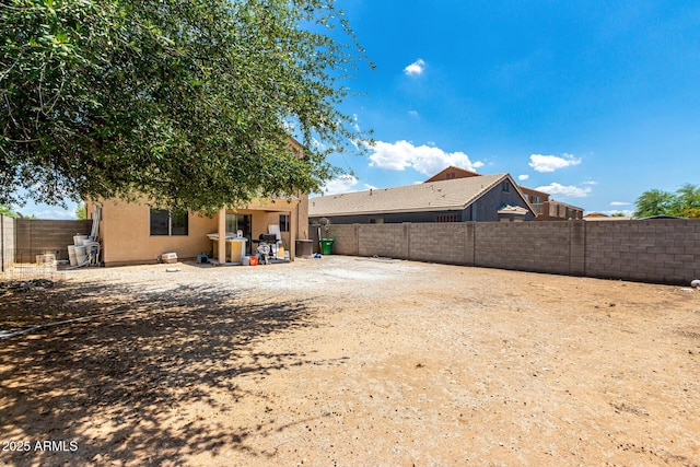9236 N 184th Ln, Waddell, AZ 85355 - rear view of house with a fenced backyard and stucco siding