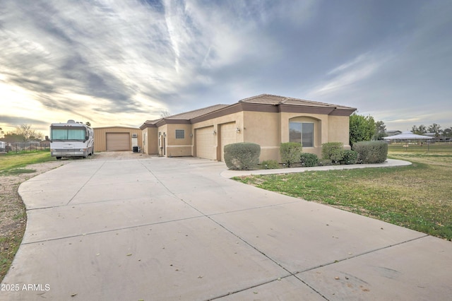 view of front of house featuring a garage and a yard