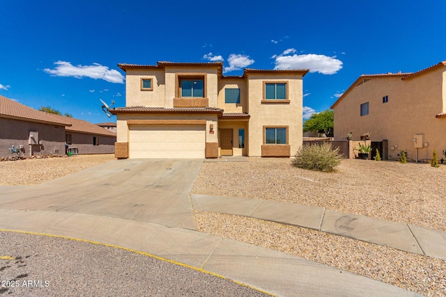 prairie-style home featuring fence, an attached garage, stucco siding, a tile roof, and concrete driveway