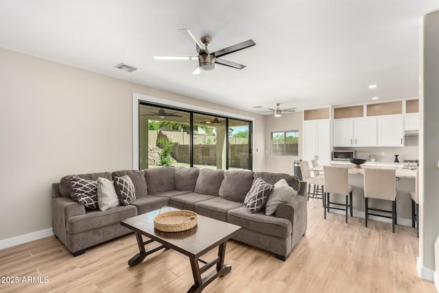 living room with a ceiling fan, recessed lighting, baseboards, light wood finished floors, and visible vents