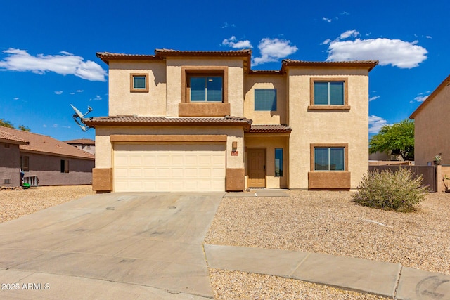 view of front of property with concrete driveway, a garage, stucco siding, and a tiled roof