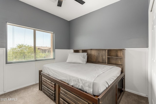 bedroom with carpet flooring, baseboards, and a ceiling fan