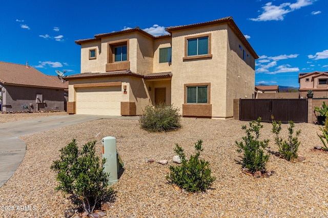 prairie-style home featuring fence, an attached garage, concrete driveway, stucco siding, and a tiled roof