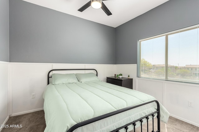 bedroom with carpet flooring, baseboards, and a ceiling fan