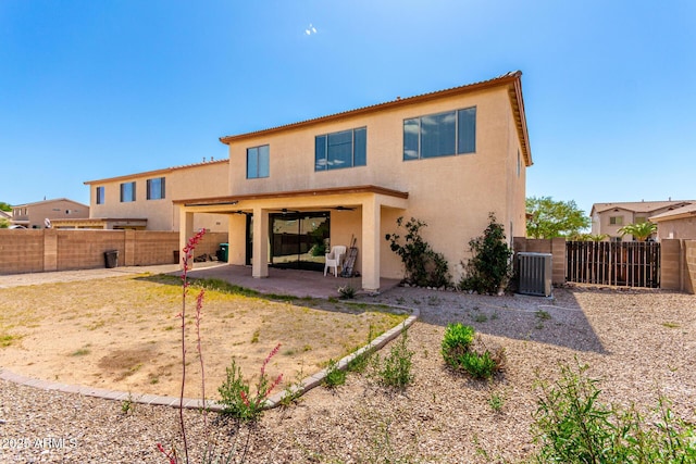 back of property featuring cooling unit, stucco siding, a fenced backyard, and a patio