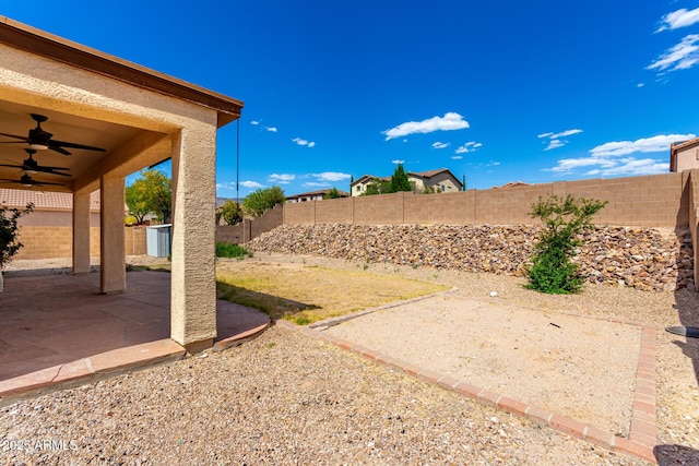 view of yard with a patio, ceiling fan, and a fenced backyard