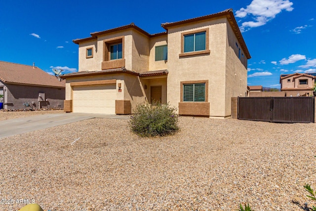 view of front facade featuring stucco siding, a tiled roof, an attached garage, and fence
