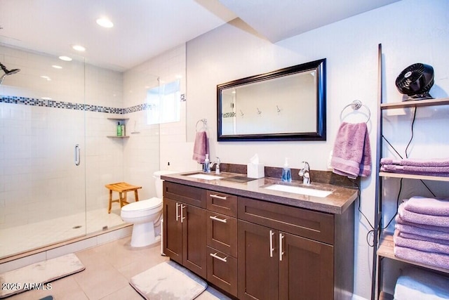 bathroom with toilet, vanity, a shower with shower door, and tile patterned floors