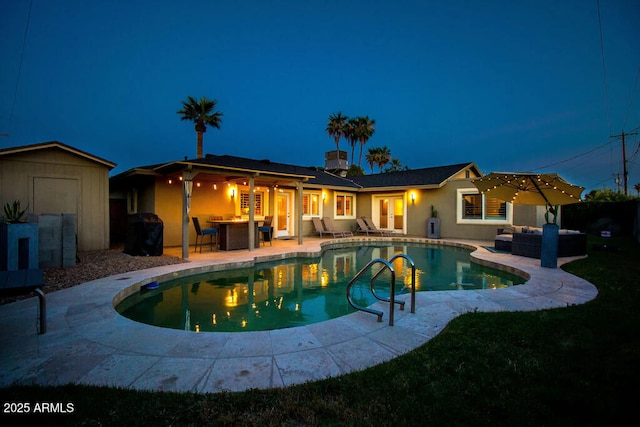 view of pool with a patio, a storage unit, and outdoor lounge area