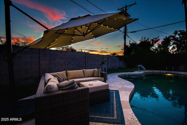 pool at dusk featuring a patio and an outdoor living space