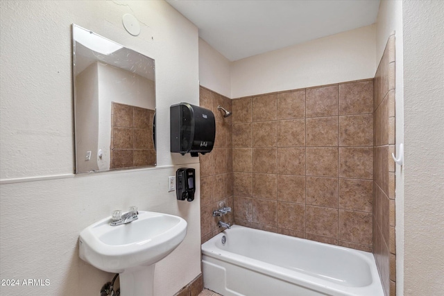 bathroom with tiled shower / bath combo and sink