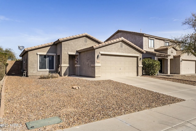 43556 W Colby Dr, Maricopa, AZ 85138 - view of front facade with concrete driveway, an attached garage, a tiled roof, and stucco siding