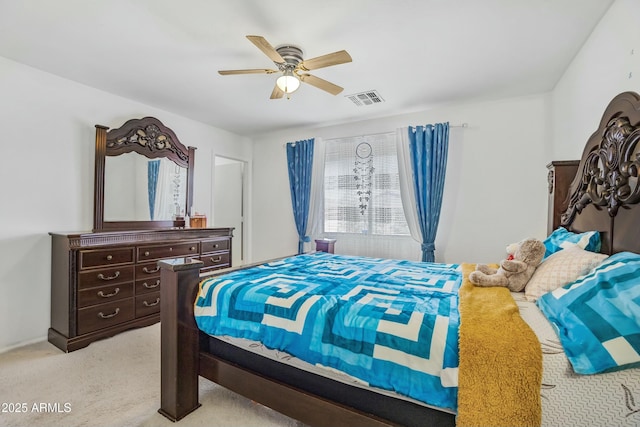 bedroom with a ceiling fan, visible vents, and light carpet