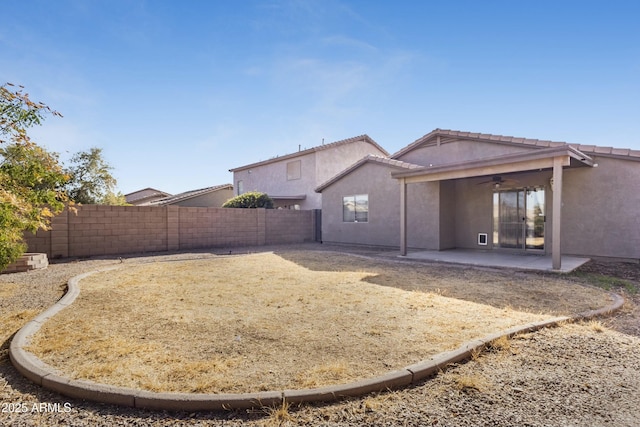 view of yard featuring ceiling fan, a patio, and a fenced backyard