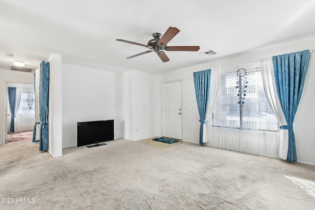 unfurnished living room with carpet flooring, visible vents, and a ceiling fan