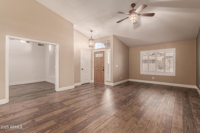 interior space with ceiling fan, dark hardwood / wood-style flooring, and vaulted ceiling