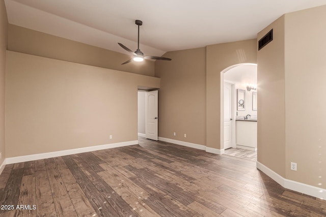 spare room with vaulted ceiling, ceiling fan, and hardwood / wood-style floors