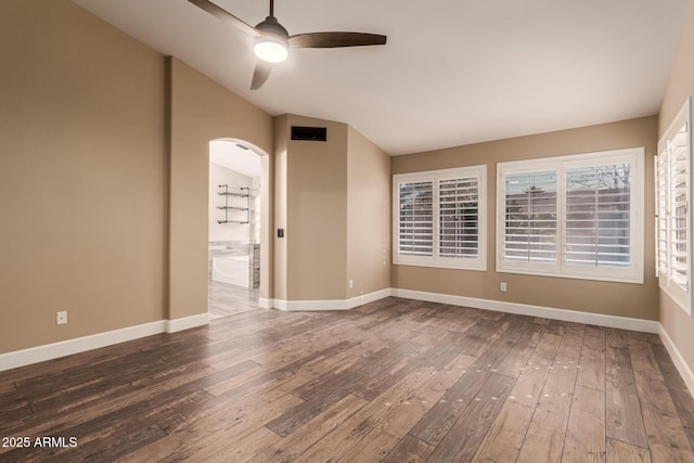 empty room featuring wood-type flooring, lofted ceiling, and ceiling fan