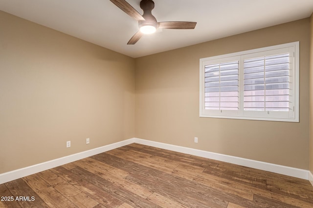 spare room with hardwood / wood-style flooring and ceiling fan