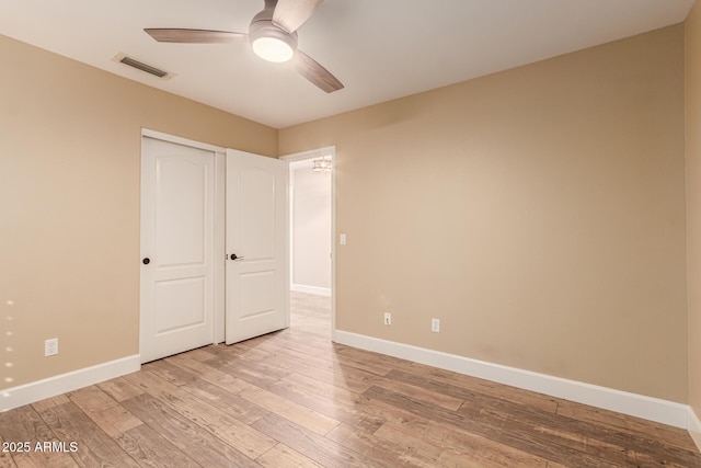 unfurnished bedroom featuring a closet, ceiling fan, and light wood-type flooring