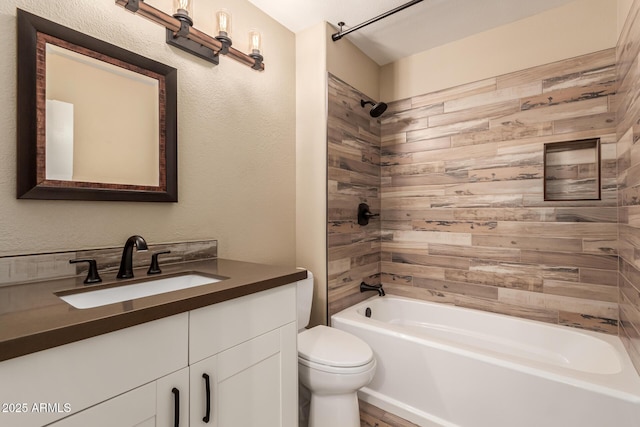 full bathroom with vanity, toilet, and tiled shower / bath combo