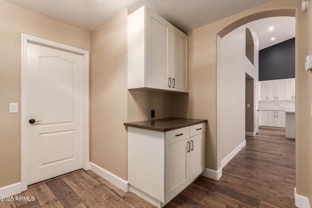 kitchen with white cabinetry and dark hardwood / wood-style floors