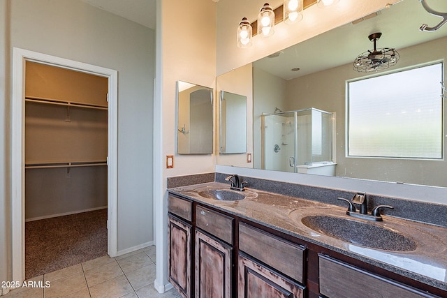 full bathroom featuring tile patterned floors, visible vents, a sink, and a shower stall