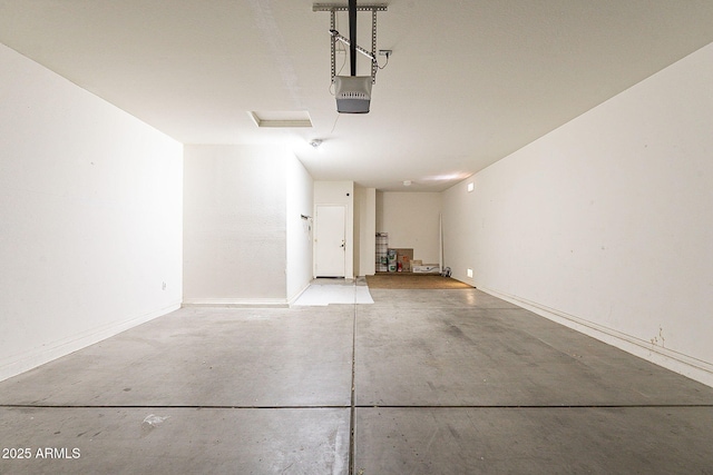 garage with a garage door opener and baseboards