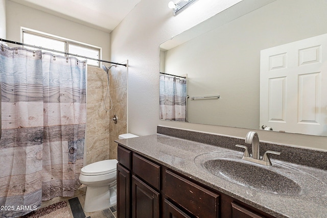 bathroom with vanity, a shower with shower curtain, and toilet