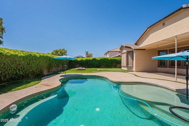view of pool with a lawn, a fenced in pool, fence private yard, and a patio