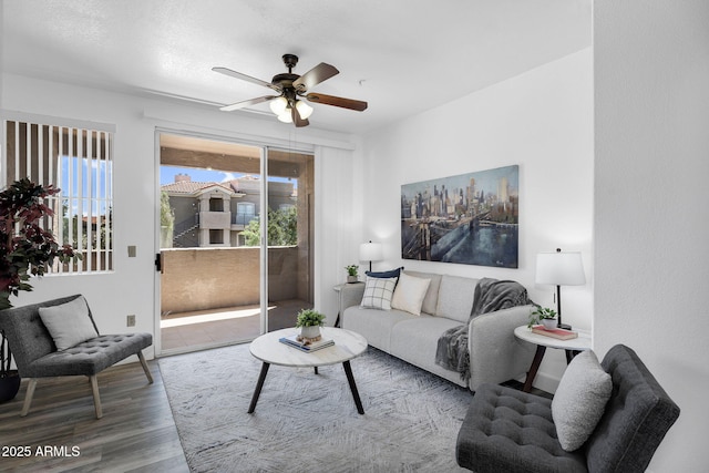 living area featuring wood finished floors and ceiling fan