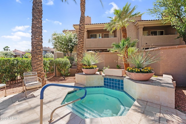 view of swimming pool featuring a hot tub and a patio