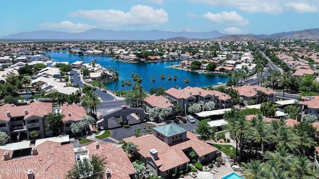aerial view of residential area featuring a water and mountain view