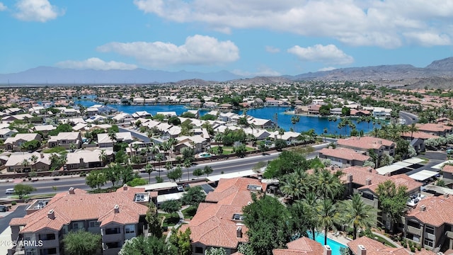 aerial view of residential area featuring a water and mountain view
